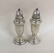 A pair of slender Sterling silver peppers. Approx.