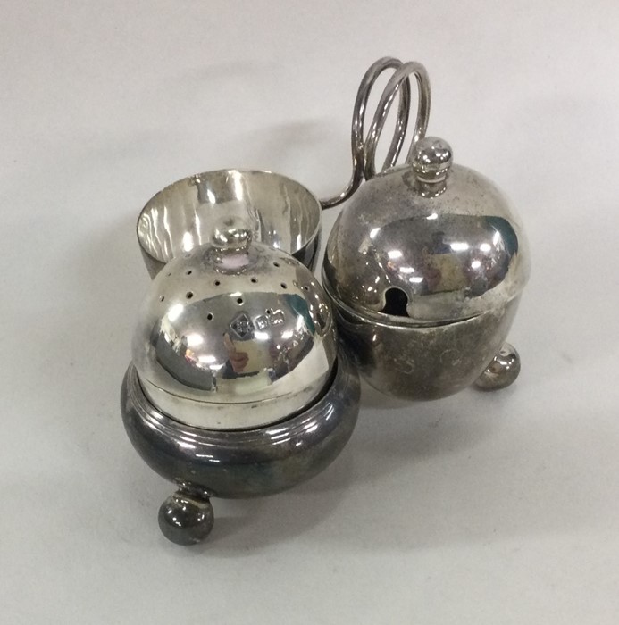 An Edwardian silver cruet of oval form on ball fee