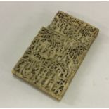 A carved ivory card case profusely decorated with