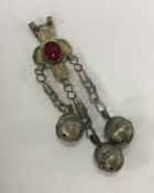 A Continental Antique silver rattle with bell deco