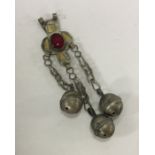 A Continental Antique silver rattle with bell deco