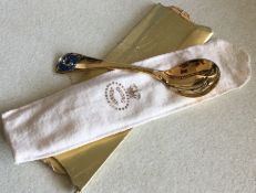 GEORG JENSEN: A silver gilt preserve spoon with fl