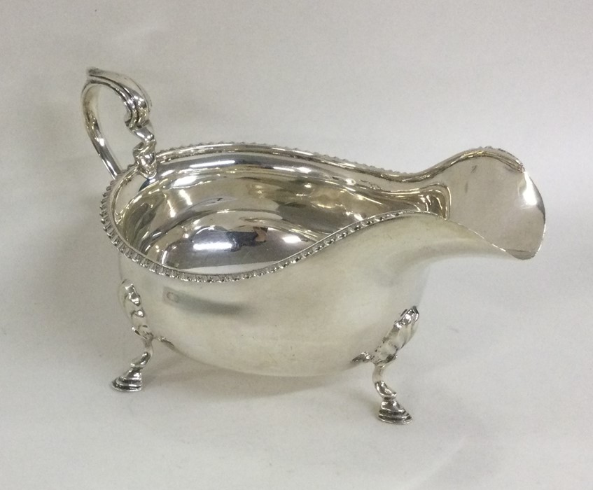 An Edwardian silver sauce boat with gadroon rim. B