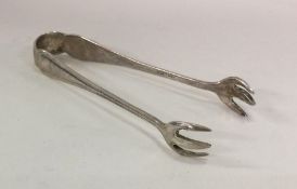 A pair of silver ice tongs with reeded decoration.