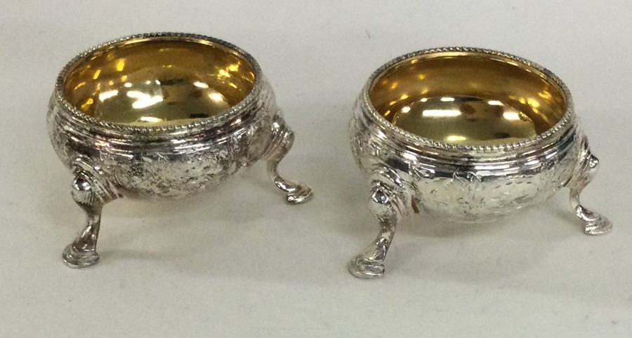 A good pair of engraved silver salts with gilt int