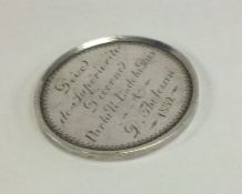 A heavy French silver medallion decorated with swa