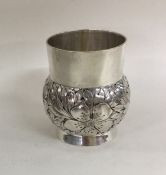 A Norwegian silver tumbler cup chased with flowers