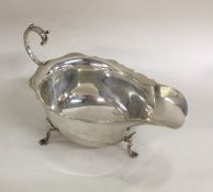 A heavy silver sauce boat with card cut rim. Birmi