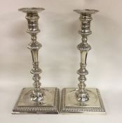 A pair of good quality cast silver candlesticks wi