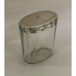 An oval silver mounted dressing table jar. London.