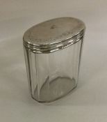 An oval silver mounted dressing table jar. London.