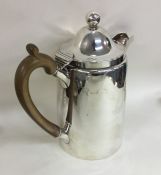 A heavy Georgian silver hinged top hot water jug.