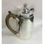 A heavy Georgian silver hinged top hot water jug.