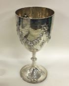 A massive silver goblet decorated with swags. Lond