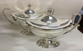 A fine pair of Georgian silver tureens with creste