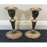 A pair of Edwardian silver candlesticks of half fl