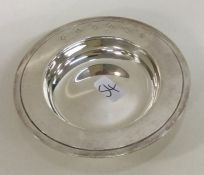 A small circular silver armada dish. London. By FH
