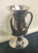 An attractive silver three handled cup / vase with