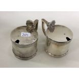 A pair of Edwardian silver mustard pots with shell