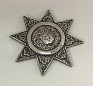 An unusual silver medal in the form of a star with