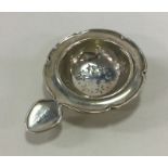 An Edwardian silver shaped tea strainer with pierc