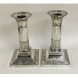 A pair of late Victorian fluted candlesticks with