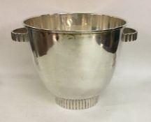 A stylish silver ice bucket on pedestal base. Appr