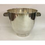 A stylish silver ice bucket on pedestal base. Appr