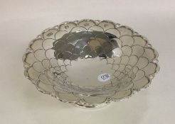 An unusual silver bonbon dish chased with flowers.