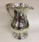 A rare George III baluster shaped beer jug on spre