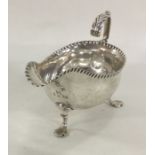 A George III silver sauce boat with crimped rim on