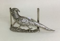 An unusual Edwardian silver menu holder cast with