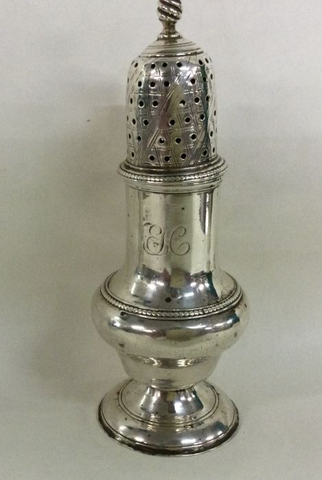 A large Georgian silver sugar caster of typical fo