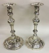 A good pair of George II silver cast candlesticks