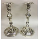 A good pair of George II silver cast candlesticks