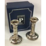 A pair of cased silver candlesticks. London. By WM
