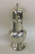 A large silver sugar caster with lift-off cover. B