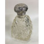 A heavy silver mounted hobnail cut scent bottle wi