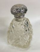 A heavy silver mounted hobnail cut scent bottle wi
