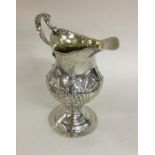 A large George III silver cream jug of shaped form