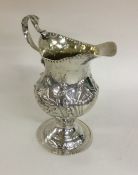 A large George III silver cream jug of shaped form