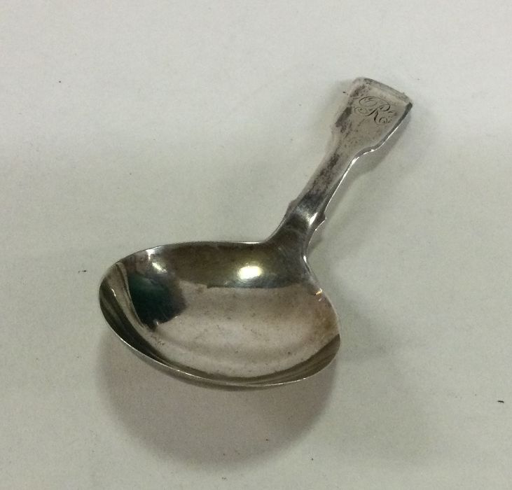 A large fiddle pattern silver caddy spoon with ini