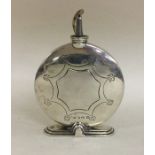 A large circular engraved silver table lighter. Bi