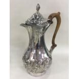 A large heavy Georgian silver ewer of half fluted