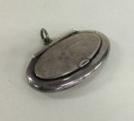 A miniature oval silver pill box with flush fittin