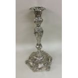 A massive George III silver candlestick with scrol