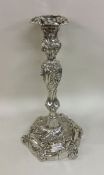 A massive George III silver candlestick with scrol
