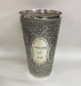 A large chased Indian silver tapering vase decorat