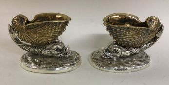 A pair of finely cast silver salts in the form of