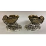 A pair of finely cast silver salts in the form of